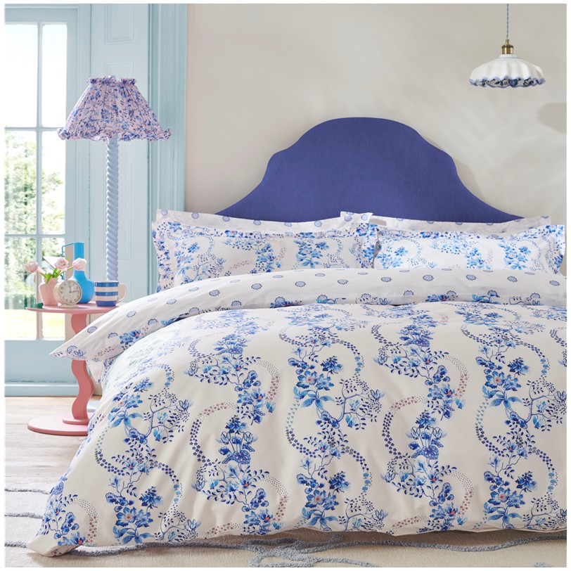 Cath Kidston Road Floral Cornflower bedset Cath Kidston Road Floral Cornflower bedset. The face features a striking blue floral swirl design, creating a vibrant and eye-catching focal point in your bedroom. On the reverse, a delicate small flower pattern adds a charming contrast, offering a touch of subtle detail. Made from high-quality 180 thread count 100% cotton, this bed set is not only stylish but also comfortable.