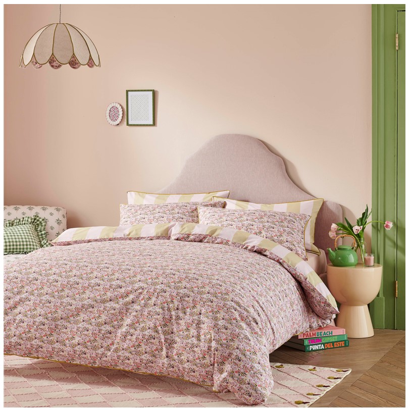 Cath Kidston Tiny Town Pink bedset Cath Kidston Tiny Town Pink bedset. This bed set showcases a whimsical pattern with vibrant, colourful details. The reverse side offers a refreshing contrast with a soft pink and green striped design. Made from 180 thread count 100% cotton, this set promises comfort and style, perfect for creating a cozy and inviting atmosphere.